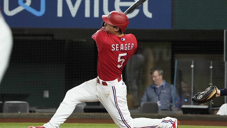 Jul 8, 2022; Arlington, Texas, USA; Texas Rangers shortstop Corey Seager (5) hits a three run home run against the Minnesota Twins during the fifth inning at Globe Life Field. Mandatory Credit: Jim Cowsert-USA TODAY Sports