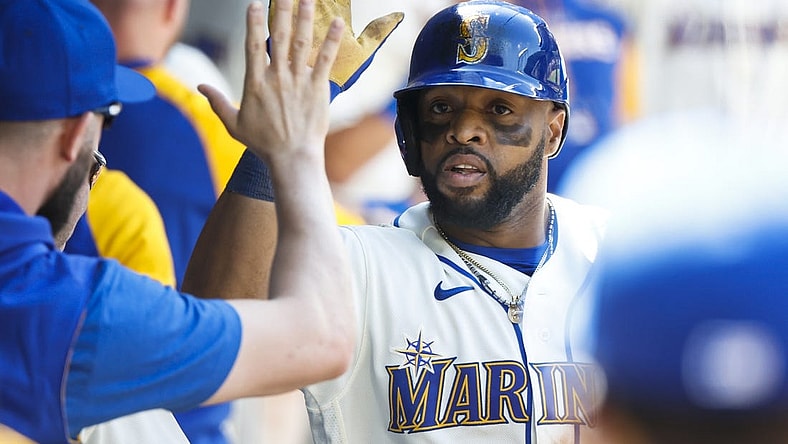 Jul 10, 2022; Seattle, Washington, USA; Seattle Mariners first baseman Carlos Santana (41) high-fives teammates in the dugout following a two-run home run against the Toronto Blue Jays during the eighth inning at T-Mobile Park. Mandatory Credit: Joe Nicholson-USA TODAY Sports