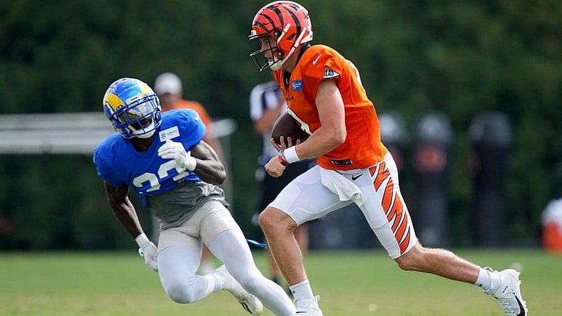 Cincinnati Bengals quarterback Joe Burrow (9) runs out of the pocket as Los Angeles Rams running back Kyren Williams (23) defends during a joint practice, Wednesday, Aug. 24, 2022, at the Paycor Stadium practice fields in Cincinnati.

Los Angeles Rams At Cincinnati Bengals Joint Practice Aug 24 0064