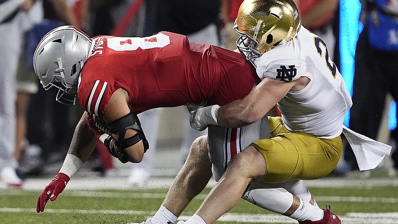 Sep 3, 2022; Columbus, Ohio, USA; Ohio State Buckeyes tight end Cade Stover (8) gets tackled by Notre Dame Fighting Irish linebacker JD Bertrand (27) after a catch in the second quarter of the NCAA football game between Ohio State Buckeyes and Notre Dame Fighting Irish at Ohio Stadium. Mandatory Credit: Kyle Robertson-USA TODAY Sports