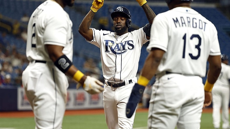 Sep 6, 2022; St. Petersburg, Florida, USA;Tampa Bay Rays left fielder Randy Arozarena (56) is congratulated by third baseman Yandy Diaz (2) and right fielder Manuel Margot (13) after he hit a three-run home run against the Boston Red Sox during the first inning at Tropicana Field. Mandatory Credit: Kim Klement-USA TODAY Sports