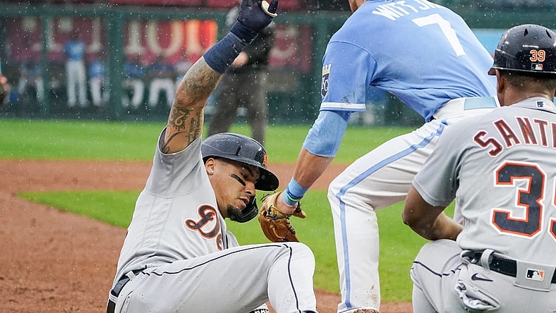 Sep 10, 2022; Kansas City, Missouri, USA; Detroit Tigers shortstop Javier Baez (28) slides into third base safely as Kansas City Royals third baseman Bobby Witt Jr. (7) waits for the throw after hitting a one-run triple in the fifth inning at Kauffman Stadium. Mandatory Credit: Denny Medley-USA TODAY Sports