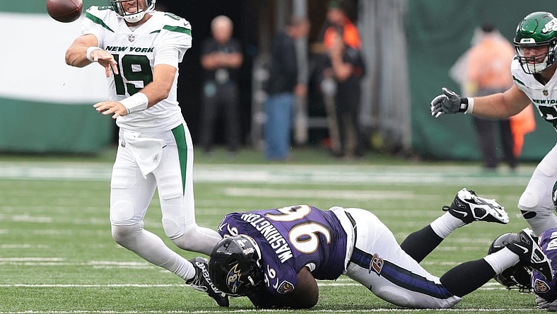 Sep 11, 2022; East Rutherford, New Jersey, USA; New York Jets quarterback Joe Flacco (19) is tackled by Baltimore Ravens defensive tackle Broderick Washington (96) while throwing the ball during the second half at MetLife Stadium. Mandatory Credit: Vincent Carchietta-USA TODAY Sports