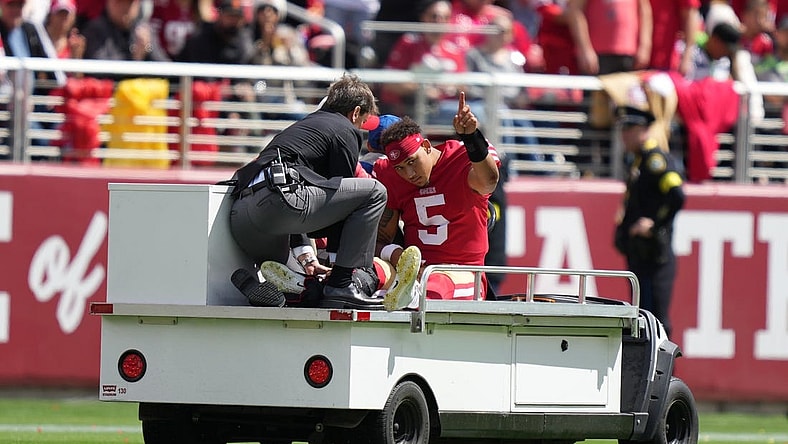 September 18, 2022; Santa Clara, California, USA; San Francisco 49ers quarterback Trey Lance (5) is carted off the field after an injury against the Seattle Seahawks during the first quarter at Levi's Stadium. Mandatory Credit: Kyle Terada-USA TODAY Sports