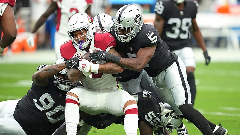 Sep 18, 2022; Paradise, Nevada, USA; Arizona Cardinals running back James Conner (6) is tackled by Las Vegas Raiders defensive tackle Johnathan Hankins (90) and Las Vegas Raiders linebacker Divine Deablo (5) during a game at Allegiant Stadium. Mandatory Credit: Stephen R. Sylvanie-USA TODAY Sports