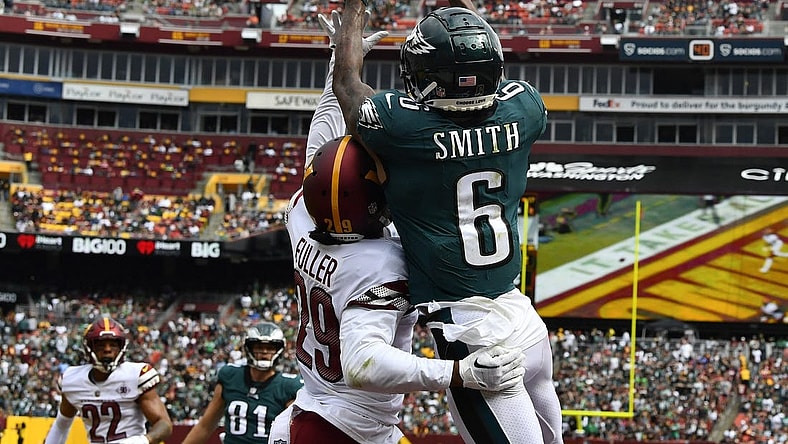 Sep 25, 2022; Landover, Maryland, USA; Philadelphia Eagles wide receiver DeVonta Smith (6) scores a touchdown over Washington Commanders cornerback Kendall Fuller (29) before the game between the Washington Commanders and the Philadelphia Eagles at FedExField. Mandatory Credit: Brad Mills-USA TODAY Sports