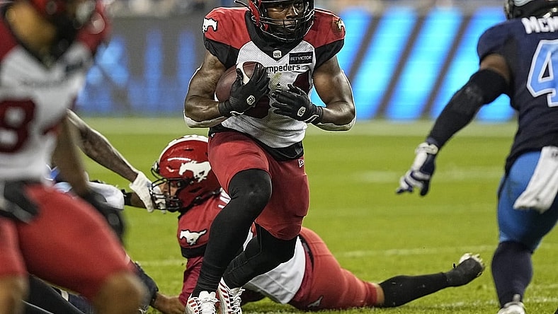 Aug 20, 2022; Toronto, Ontario, CAN; Calgary Stampeders running back Dedrick Mills (34) runs the football against the Toronto Argonauts during the second half at BMO Field. Mandatory Credit: John E. Sokolowski-USA TODAY Sports