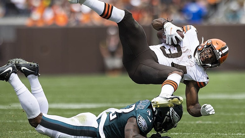 Aug 21, 2022; Cleveland, Ohio, USA; Cleveland Browns running back Jerome Ford (34) flies over Philadelphia Eagles safety K'Von Wallace (42) following his tackle during the second quarter at FirstEnergy Stadium. Mandatory Credit: Scott Galvin-USA TODAY Sports
