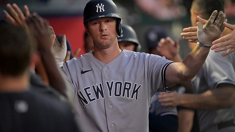 Aug 29, 2022; Anaheim, California, USA;  New York Yankees third baseman DJ LeMahieu (26) is greeted in the dugout after a sacrifice bunt scored a run in the fourth inning against the Los Angeles Angels at Angel Stadium. Mandatory Credit: Jayne Kamin-Oncea-USA TODAY Sports