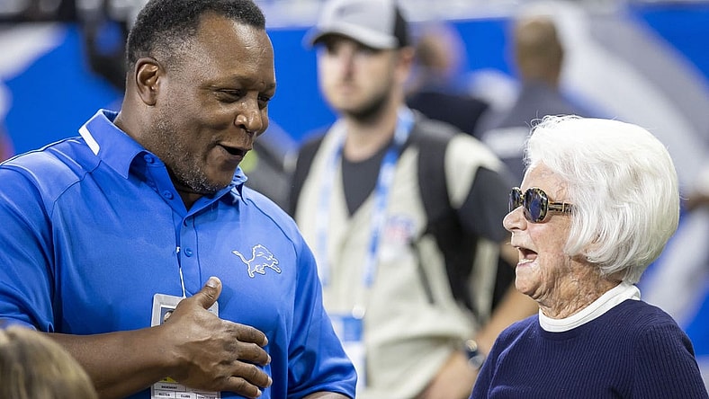 Sep 11, 2022; Detroit, Michigan, USA; Former Detroit Lions Barry Sanders chat with Owner/Chair Emeritus of the Detroit Lions Martha Firestone Ford before the start of the NFL game against the Philadelphia Eagles at Ford Field. Mandatory Credit: David Reginek-USA TODAY Sports