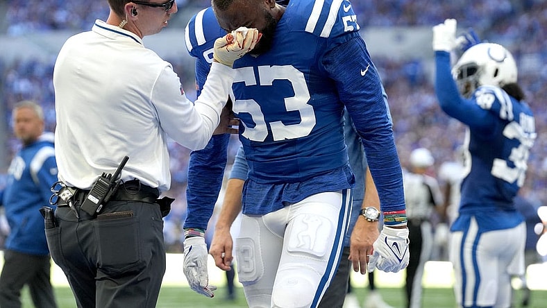 Oct 2, 2022; Indianapolis, Indiana, USA; Indianapolis Colts assistant athletic trainer Kyle Davis tends to linebacker Shaquille Leonard (53) after a play against the Tennessee Titans during the first half at Lucas Oil Stadium. Mandatory Credit: Jenna Watson/IndyStar-USA TODAY NETWORK