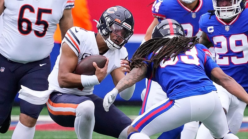 Oct 2, 2022; East Rutherford, New Jersey, USA; Chicago Bears quarterback Justin Fields (1) runs with the ball for a first down against the New York Giants during the first half at MetLife Stadium. Mandatory Credit: Robert Deutsch-USA TODAY Sports