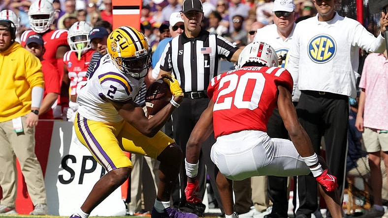 Oct 22, 2022; Baton Rouge, Louisiana, USA;  LSU Tigers wide receiver Kyren Lacy (2) is tackled by Mississippi Rebels cornerback Davison Igbinosun (20) during the first half at Tiger Stadium. Mandatory Credit: Stephen Lew-USA TODAY Sports