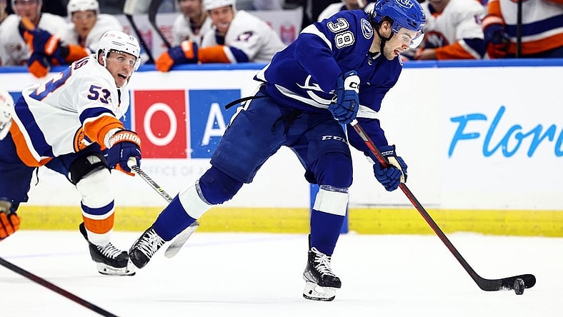 Oct 22, 2022; Tampa, Florida, USA; Tampa Bay Lightning left wing Brandon Hagel (38) skates with the puck against New York Islanders center Casey Cizikas (53) during the third period at Amalie Arena. Mandatory Credit: Kim Klement-USA TODAY Sports