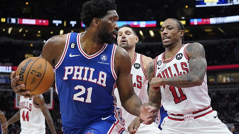 Oct 29, 2022; Chicago, Illinois, USA; Philadelphia 76ers center Joel Embiid (21) is defended by Chicago Bulls forward DeMar DeRozan (11) during the second half at United Center. Mandatory Credit: David Banks-USA TODAY Sports