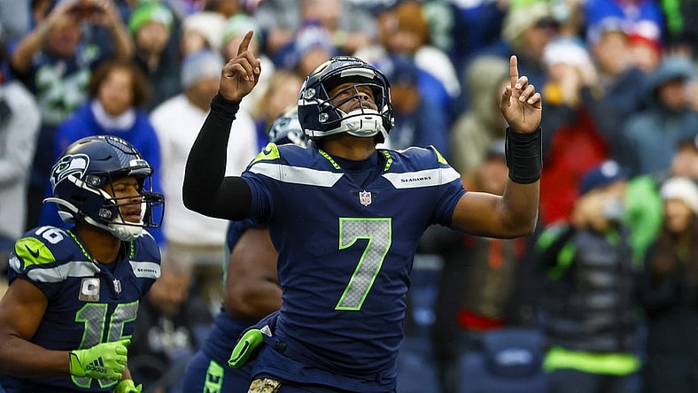 Oct 30, 2022; Seattle, Washington, USA; Seattle Seahawks quarterback Geno Smith (7) celebrates after throwing a touchdown pass to wide receiver Tyler Lockett (16) during the fourth quarter against the New York Giants at Lumen Field. Mandatory Credit: Joe Nicholson-USA TODAY Sports