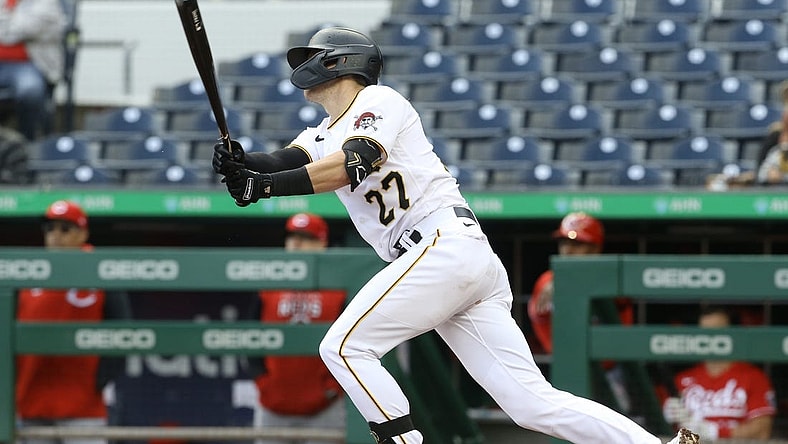 Sep 28, 2022; Pittsburgh, Pennsylvania, USA; Pittsburgh Pirates second baseman Kevin Newman (27) hits a game winning single to defeat the Cincinnati Reds in ten innings at PNC Park. The Pirates won 4-3 in ten innings. Mandatory Credit: Charles LeClaire-USA TODAY Sports