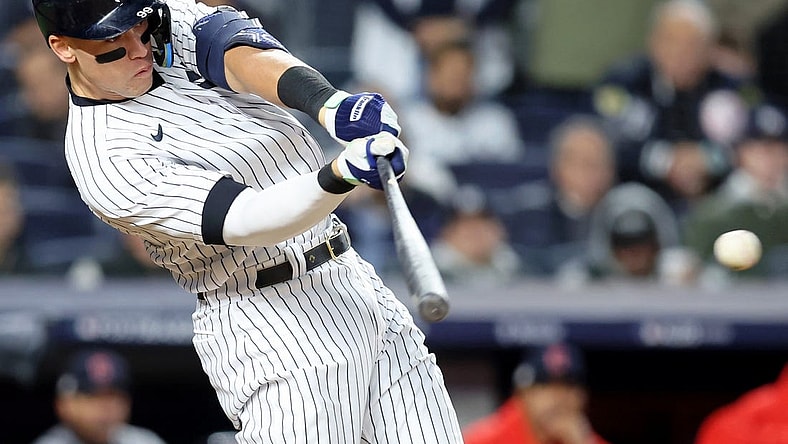 Oct 18, 2022; Bronx, New York, USA; New York Yankees right fielder Aaron Judge (99) hits a single against the Cleveland Guardians during the seventh inning in game five of the ALDS for the 2022 MLB Playoffs at Yankee Stadium. Mandatory Credit: Brad Penner-USA TODAY Sports