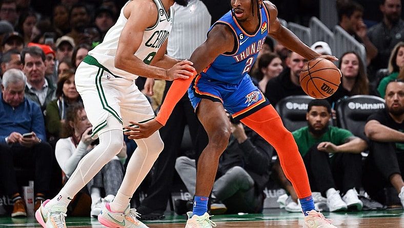 Nov 14, 2022; Boston, Massachusetts, USA; Oklahoma City Thunder guard Shai Gilgeous-Alexander (2) dribbles the ball against Boston Celtics guard Derrick White (9) during the first half at the TD Garden. Mandatory Credit: Brian Fluharty-USA TODAY Sports