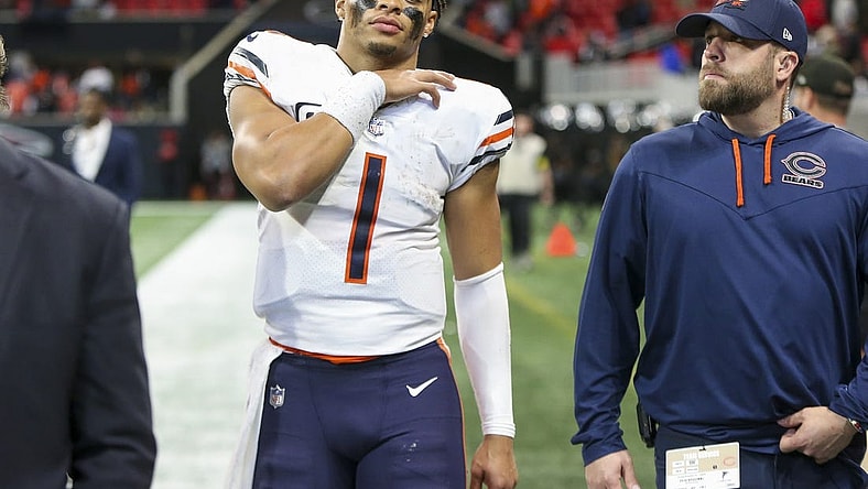 Nov 20, 2022; Atlanta, Georgia, USA; Chicago Bears quarterback Justin Fields (1) walks off the field with medical personnel after a game against the Atlanta Falcons at Mercedes-Benz Stadium. Mandatory Credit: Brett Davis-USA TODAY Sports