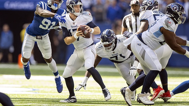 Oct 2, 2022; Indianapolis, Indiana, USA;  Tennessee Titans quarterback Ryan Tannehill (17) narrowly misses being sacked by Indianapolis Colts defensive end Yannick Ngakoue (91) during the first quarter at Lucas Oil Stadium. Mandatory Credit: Marc Lebryk-USA TODAY Sports