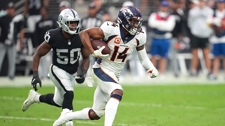 Oct 2, 2022; Paradise, Nevada, USA; Denver Broncos wide receiver Courtland Sutton (14) runs with the ball ahead of Las Vegas Raiders linebacker Jayon Brown (50) during a game at Allegiant Stadium. Mandatory Credit: Stephen R. Sylvanie-USA TODAY Sports