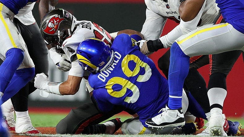 Nov 6, 2022; Tampa, Florida, USA;  Tampa Bay Buccaneers quarterback Tom Brady (12) is sacked by Los Angeles Rams defensive tackle Aaron Donald (99) in the third quarter at Raymond James Stadium. Mandatory Credit: Nathan Ray Seebeck-USA TODAY Sports