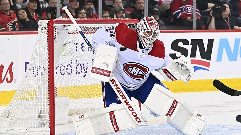 Dec 1, 2022; Calgary, Alberta, CAN; Montreal Canadiens  goalie Jake Allen (34) stops a shot from the Calgary Flames in the second period at Scotiabank Saddledome. Mandatory Credit: Candice Ward-USA TODAY Sports