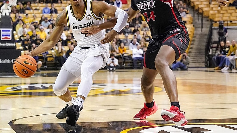 Dec 4, 2022; Columbia, Missouri, USA; Missouri Tigers guard DeAndre Gholston (4) dribbles as Southeast Missouri State Redhawks center Nate Johnson (14) defends during the first half at Mizzou Arena. Mandatory Credit: Denny Medley-USA TODAY Sports