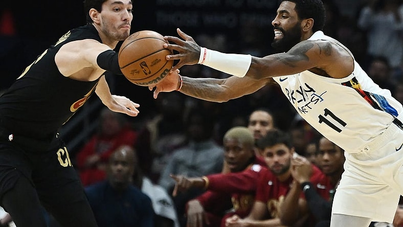 Dec 26, 2022; Cleveland, Ohio, USA; Cleveland Cavaliers forward Cedi Osman (16) and Brooklyn Nets guard Kyrie Irving (11) go for a loose ball during the second half at Rocket Mortgage FieldHouse. Mandatory Credit: Ken Blaze-USA TODAY Sports