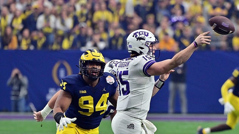 Dec 31, 2022; Glendale, Arizona, USA; TCU Horned Frogs quarterback Max Duggan (15) passes against Michigan Wolverines defensive lineman Kris Jenkins (94) in the second quarter of the 2022 Fiesta Bowl at State Farm Stadium. Mandatory Credit: Matt Kartozian-USA TODAY Sports