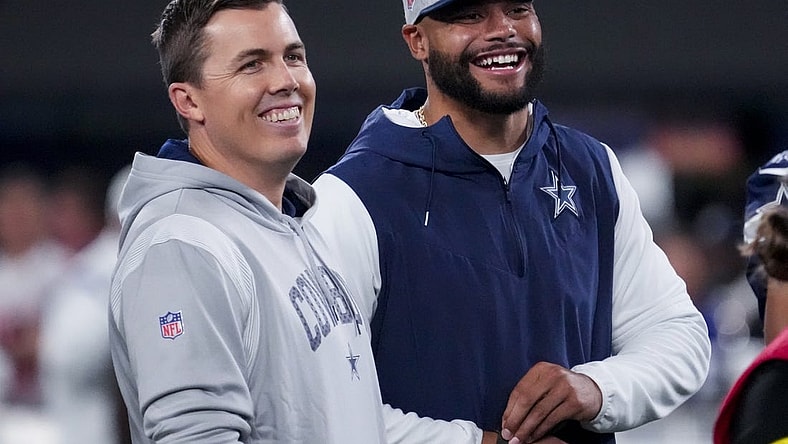 Sep 26, 2022; East Rutherford, New Jersey, USA;  Dallas Cowboys quarterback Dak Prescott (right) laughs with offensive coordinator Kellen Moore before the game against the New York Giants at MetLife Stadium. Mandatory Credit: Robert Deutsch-USA TODAY Sports