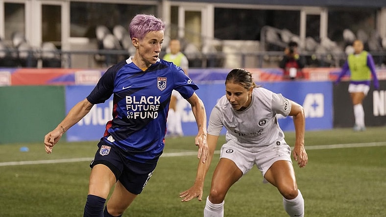 Oct 1, 2022; Seattle, Washington, USA; OL Reign forward Megan Rapinoe (15) controls the ball against Orlando Pride defender Kylie Strom (23)in the first half at Lumen Field. Mandatory Credit: Stephen Brashear-USA TODAY Sports