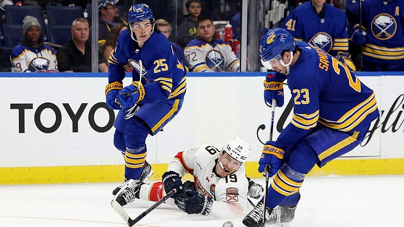 Oct 15, 2022; Buffalo, New York, USA; Buffalo Sabres defenseman Owen Power (25) watches as Florida Panthers left wing Matthew Tkachuk (19) dives to clear the puck from Buffalo Sabres defenseman Mattias Samuelsson (23) during the third period at KeyBank Center. Mandatory Credit: Timothy T. Ludwig-USA TODAY Sports