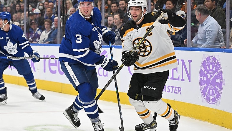 Nov 5, 2022; Toronto, Ontario, CAN; Toronto Maple Leafs defenseman Justin Holl (3) covers Boston Bruins forward Patrice Bergeron (37) in the third period at Scotiabank Arena. Mandatory Credit: Dan Hamilton-USA TODAY Sports
