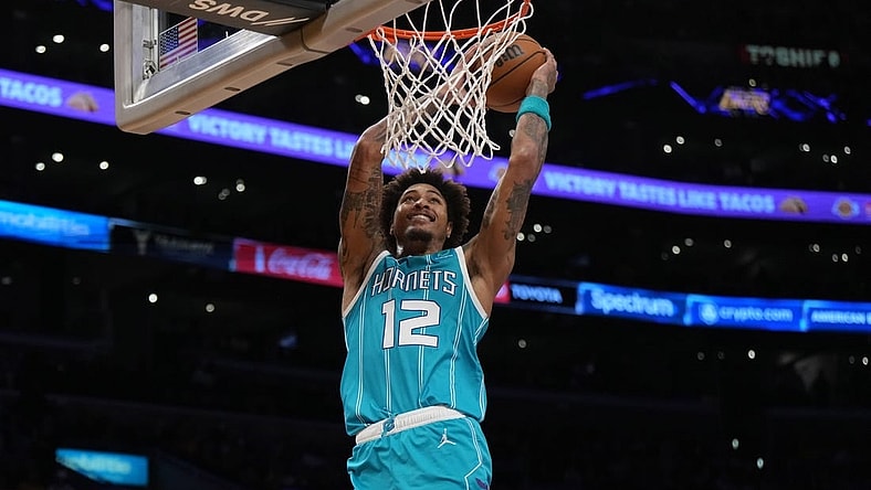 Dec 23, 2022; Los Angeles, California, USA; Charlotte Hornets guard Kelly Oubre Jr. (12) dunks the ball against the Los Angeles Lakers in the first half at Crypto.com Arena. Mandatory Credit: Kirby Lee-USA TODAY Sports