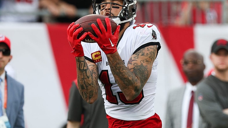 Jan 1, 2023; Tampa, Florida, USA; Tampa Bay Buccaneers wide receiver Mike Evans (13) catches a pass from touchdown against the Carolina Panthers in the second quarter at Raymond James Stadium. Mandatory Credit: Nathan Ray Seebeck-USA TODAY Sports