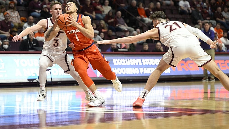 Jan 4, 2023; Blacksburg, Virginia, USA; Clemson Tigers guard Chase Hunter (1) drives to basket between Virginia Tech Hokies guard Sean Pedulla (3) and forward Grant Basile (21)  in the first halfat Cassell Coliseum. Mandatory Credit: Lee Luther Jr.-USA TODAY Sports