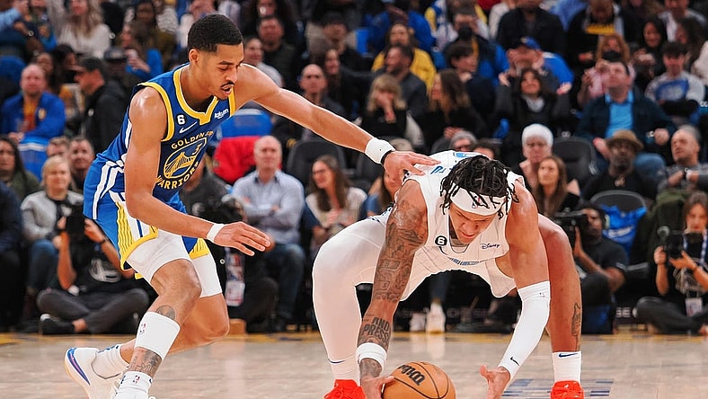 Jan 7, 2023; San Francisco, California, USA; Orlando Magic power forward Paolo Banchero (right) gathers the ball against Golden State Warriors shooting guard Jordan Poole (3) during the second quarter at Chase Center. Mandatory Credit: Kelley L Cox-USA TODAY Sports