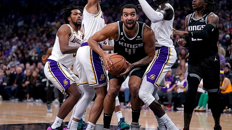 Jan 7, 2023; Sacramento, California, USA; Sacramento Kings forward Trey Lyles (41) holds onto the ball between Los Angeles Lakers guard Max Christie (10) and forward Wenyen Gabriel (35) in the first quarter at the Golden 1 Center. Mandatory Credit: Cary Edmondson-USA TODAY Sports
