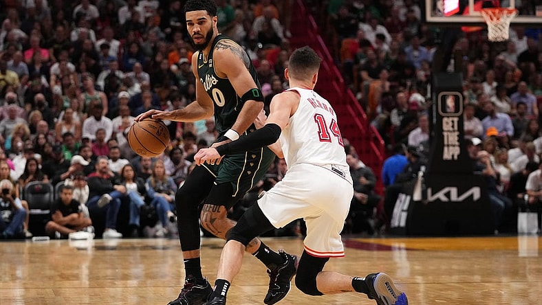 Jan 24, 2023; Miami, Florida, USA; Boston Celtics forward Jayson Tatum (0) dribbles the ball around Miami Heat guard Tyler Herro (14) during the second half at Miami-Dade Arena. Mandatory Credit: Jasen Vinlove-USA TODAY Sports