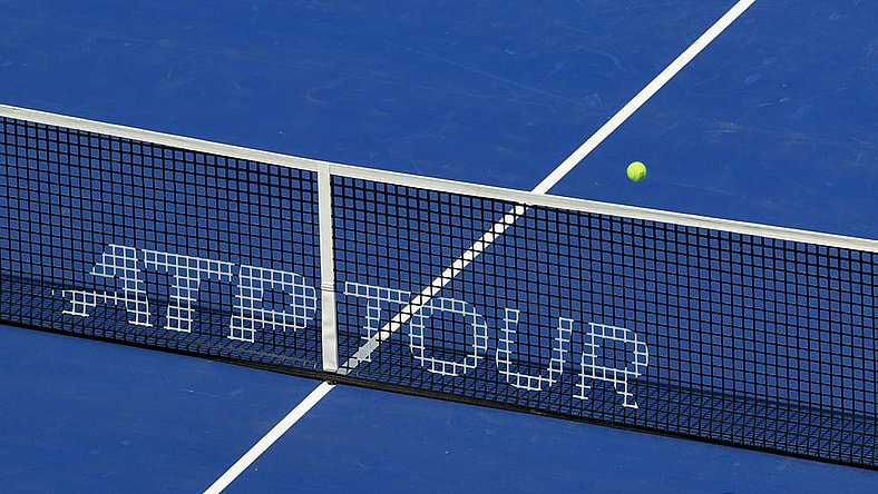 Aug 14, 2021; Mason, OH, USA; A view of the ATP Tour logo on the Center Court net as an official ball is in play during the Western and Southern Open tennis tournament at Lindner Family Tennis Center. Mandatory Credit: Aaron Doster-USA TODAY Sports