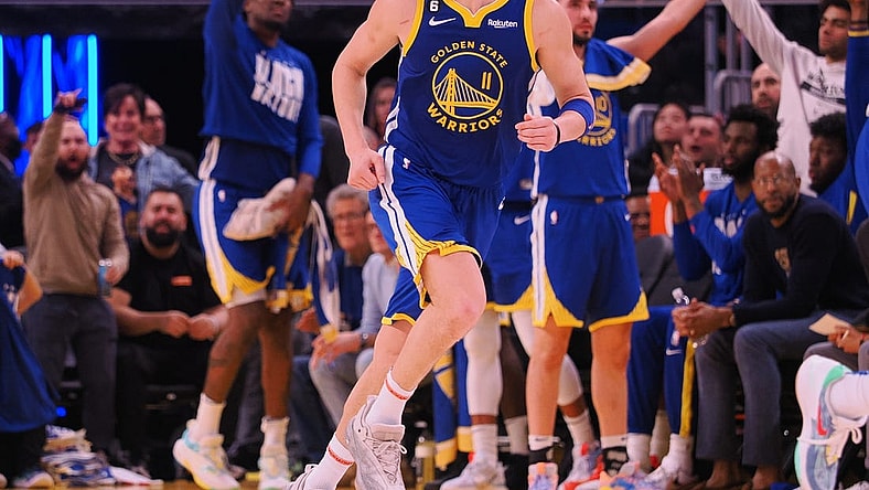 Feb 6, 2023; San Francisco, California, USA; The Golden State Warriors bench celebrates behind shooting guard Klay Thompson (11) after Thompson scored a three point basket against the Oklahoma City Thunder during the fourth quarter at Chase Center. Mandatory Credit: Kelley L Cox-USA TODAY Sports