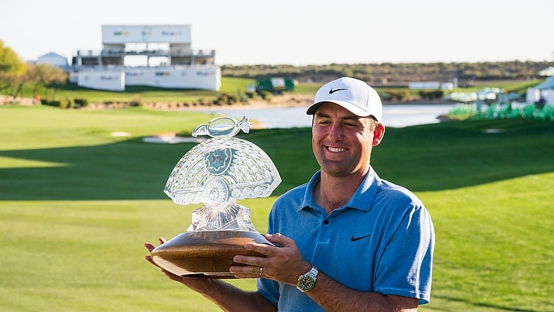 Feb 12, 2023; Scottsdale, Arizona,USA; Scotty Scheffler celebrates with the championship trophy after his victory during the final round of the WM Phoenix Open golf tournament. Mandatory Credit: Allan Henry-USA TODAY Sports