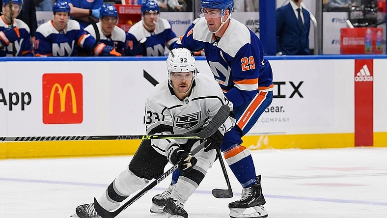 Feb 24, 2023; Elmont, New York, USA; Los Angeles Kings right wing Viktor Arvidsson (33) skates with the puck defended by New York Islanders center Brock Nelson (29) during the first period at UBS Arena. Mandatory Credit: Dennis Schneidler-USA TODAY Sports