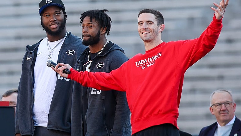 Jan 14, 2023; Athens, GA, USA; Georgia Bulldogs offensive lineman Sedrick Van Pran (63) and defensive back Christopher Smith (29) and quarterback Stetson Bennett (13) speak at the national championship celebration at Sanford Stadium. Mandatory Credit: Brett Davis-USA TODAY Sports