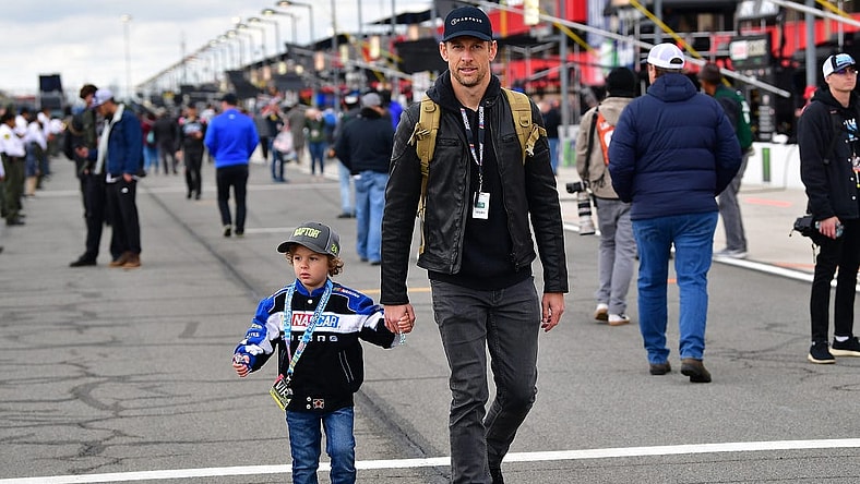 Feb 26, 2023; Fontana, California, USA; Former formula one driver Jenson Button with son Hendrix in attendance at the Pala Casino 400 at Auto Club Speedway. Mandatory Credit: Gary A. Vasquez-USA TODAY Sports