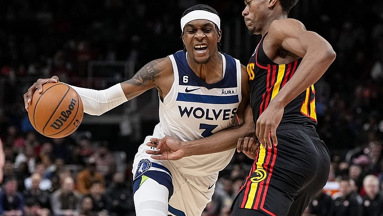 Mar 13, 2023; Atlanta, Georgia, USA; Minnesota Timberwolves guard Jordan McLaughlin (6) dribbles against Atlanta Hawks forward De'Andre Hunter (12) during the first half at State Farm Arena. Mandatory Credit: Dale Zanine-USA TODAY Sports