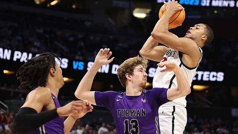 Mar 18, 2023; Orlando, FL, USA;  San Diego State Aztecs forward Jaedon LeDee (13) pulls down a rebound against Furman Paladins forward Garrett Hien (13) during the first half in the second round of the 2023 NCAA Tournament at Legacy Arena. Mandatory Credit: Matt Pendleton-USA TODAY Sports