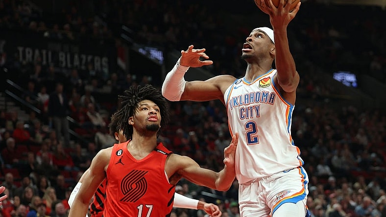 Mar 26, 2023; Portland, Oregon, USA; Oklahoma City Thunder guard Shai Gilgeous-Alexander (2) shoots the ball over Portland Trail Blazers guard Shaedon Sharpe (17) in the first half at Moda Center. Mandatory Credit: Jaime Valdez-USA TODAY Sports